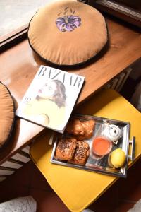 a table with a tray of pastries and a magazine at La Mandorla studio apartment in Piazza del Duomo in Florence