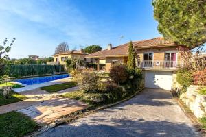 a house with a driveway and a garage at Catalunya Casas Unique Costa Brava Abode with train access to BCN in Sils