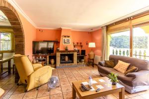 a living room with a couch and a fireplace at Catalunya Casas Spacious, Sublime Villa just 15km to Barcelona! in Torrelles de Llobregat