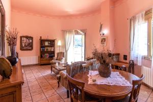 a living room with a table and chairs at Catalunya Casas Spacious, Sublime Villa just 15km to Barcelona! in Torrelles de Llobregat