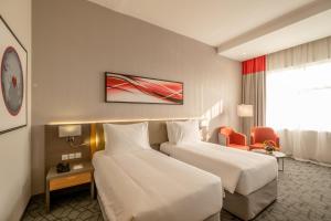 Postel nebo postele na pokoji v ubytování Peony Hotel