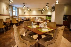a dining room with wooden tables and chairs at Vision Imperial Hotel Formerly Excelsior Hotel Downtown in Dubai