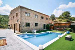 an external view of a house with a swimming pool at Catalunya Casas Wow! Boutique hotel converted into a private villa! in Rubio