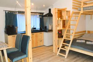 a room with two bunk beds and a kitchen at DoliAnna in Krasnobród