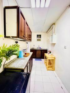 a kitchen with a sink and a counter top at Private 2Bedroom Villa with T&B and Kitchenette near Abu Dhabi International Airport in Abu Dhabi