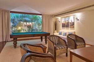a living room with a pool table and a couch at PortoBay Serra Golf in Santo António da Serra