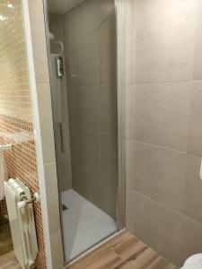 a shower with a glass door in a bathroom at La Paz in Almansa