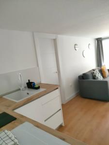 a kitchen with a desk and a couch in a room at La Paz in Almansa