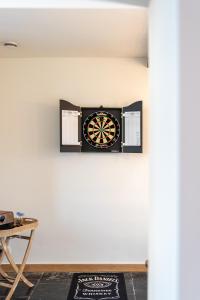 a dart board on the wall of a room at Maison de vacances Le Vieux Marronnier in Dinant
