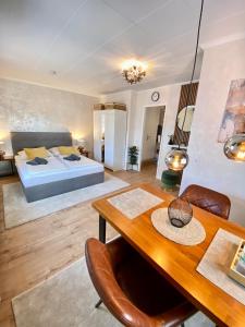 a bedroom with a bed and a wooden table and chairs at Schulz Apartments Zentrum in Bonn