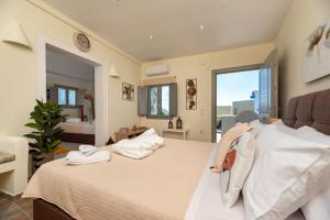 a bedroom with a bed with towels on it at Horizon Sky House with view in Pirgos