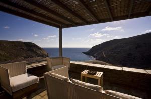 a balcony with chairs and a view of the ocean at Aegea Blue Cycladic Resort in Zorgos 