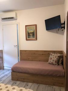 um quarto com uma cama e uma televisão de ecrã plano em Casa Mia em Verona