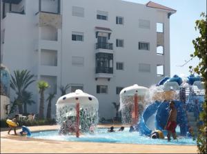 a group of children playing in a water park at Chez Marya Asilah Marina Golf uniquement famille in Asilah