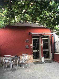 Un patio con sillas y una mesa frente a un edificio. en Affittacamere Casa Mia, en Verona