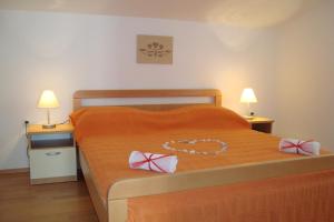 Postel nebo postele na pokoji v ubytování Apartments Bulicic