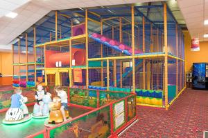 a play area with children in a play facility at Natalies Retreat Skipsea Sands in Ulrome