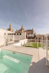 a swimming pool on the roof of a building at Indulge en Sevilla Cuna in Seville