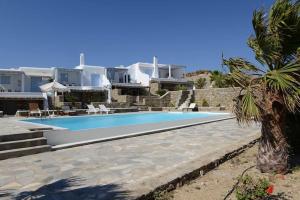 a swimming pool in front of a villa at Villa Anna in Elia Beach