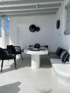 a white dining room with a white table and chairs at Villa Anna in Elia Beach