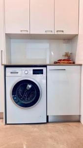 a white washer and dryer in a kitchen at Designer Studio in Sydney
