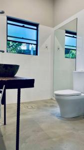 a bathroom with a toilet and a table and a window at Designer Studio in Sydney