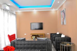 a living room with a couch and a tv at Forefront Self-Catering Apartments in Kitwe