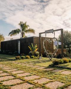 a garden with a swing and a sign at Bruval Eco Retreat in Sandim