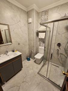 a bathroom with a shower and a toilet and a sink at Gul Sultan Hotel in Istanbul