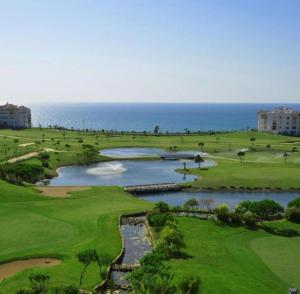an aerial view of a golf course with two ponds at Chez Marya Asilah Marina Golf uniquement famille in Asilah