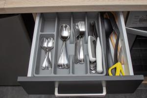 a drawer with silver utensils in it at Broadway Apartments B2 in Debrecen