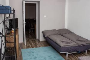 a bed sitting in a room with a doorway at Broadway Apartments B2 in Debrecen