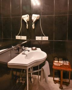 a bathroom with a sink and a mirror at Ranbanka Palace in Jodhpur