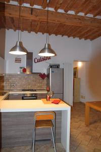 a kitchen with a white counter and two pendant lights at San Giovanni in Livorno