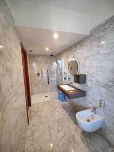 a bathroom with a sink and a shower at Hotel Meridiana in Sirmione