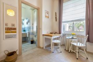 a room with a table and chairs and a bedroom at Affittacamere da Marianna in Alghero