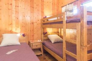a bedroom with two bunk beds in a cabin at Cocoon with garden and beautiful mountain view in Le Monêtier-les-Bains