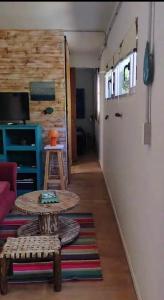 a living room with a table and a door at El Trotamundos in Puerto Pirámides