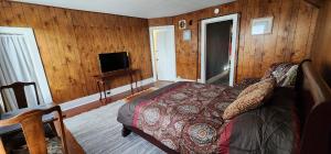 a bedroom with a bed and a flat screen tv at Super Spacious 1 bedroom w/n walking dist' to town in Manistee