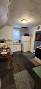 an office room with a table and a refrigerator at Super Spacious 1 bedroom w/n walking dist' to town in Manistee