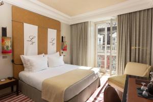 a hotel room with a large bed and a window at Heritage Avenida Liberdade - Lisbon Heritage Collection - Avenida in Lisbon +37 photos