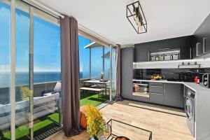 a kitchen and living room with a view of the ocean at Sea view - 5min Monaco - Swimming pool in Cap d'Ail
