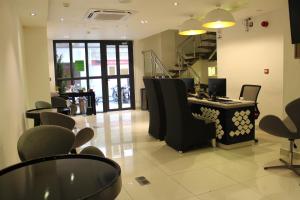 a salon with chairs and a desk in a room at Beehive Premier in Male City