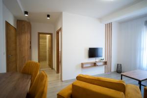 a living room with a couch and a table at Apartments and rooms SMILE in Mostar