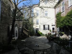 a patio with a table and chairs in front of a building at Historic 86 Church Street in Charleston