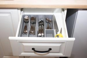 a white drawer with silver utensils in it at Broadway Apartments B1 in Debrecen