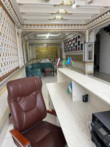 a living room with a couch and a chair at TEMUR Hotel in Bukhara