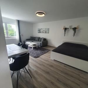 a bedroom with a bed and a table and a couch at Bonn/Königswinter ferienwohnung in Königswinter