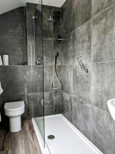 a bathroom with a shower and a toilet at The Westcott by the Sea - Just for Adults in Falmouth