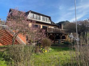 a large house with a porch and stairs to it at Ferienwohnung Moselglück in Burgen